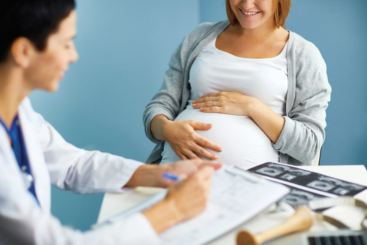 Happy Expectant Mother in Gynecologists Office